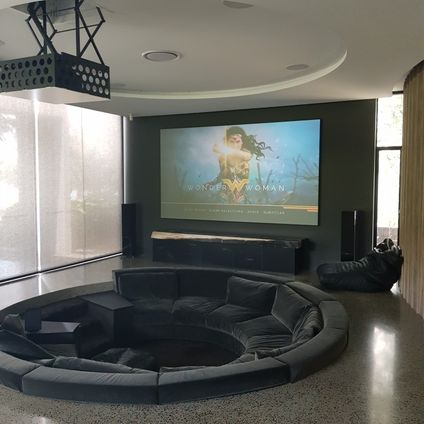 Drop down projector system in a room with a sunken lounge